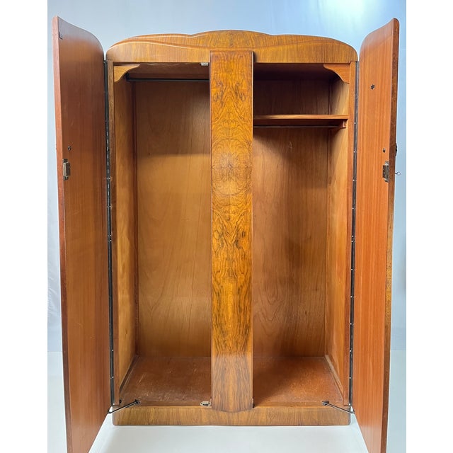 Striking vintage Art Deco wardrobe crafted in spectacular book-matched burl walnut, manufactured by British maker Durable...