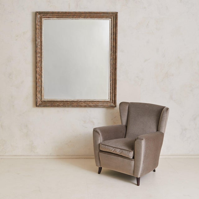 Sold and priced individually. A large-scale French rectangular wall mirror from the 1940s, with a deeply profiled wooden...