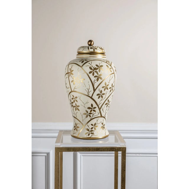 Gilded Arbor is a hand painted and lacquer collection of jar and lighting that depicts a golden spring. Blooming flowers...
