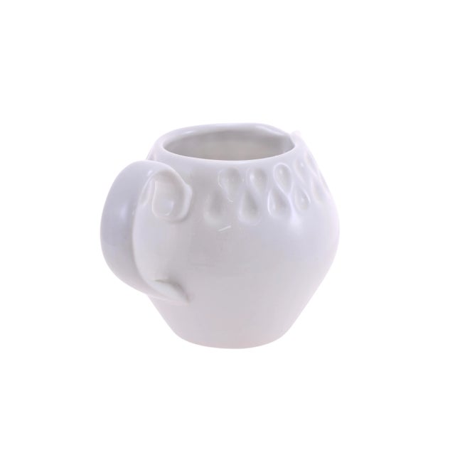 Off white ball shape pitcher with a textured feather tear raindrop design on neck and body. Marked “Iroquois Genuine...