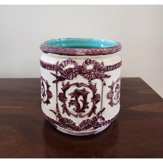 A lovely English majolica jardinière with amethyst foliate scroll on white with gorgeous turquoise glaze interior. Marked...