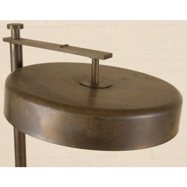 Beautiful, versatile floor lamp with a lovely patina. shade faces down or flips up. Normal wear for an item of its age.