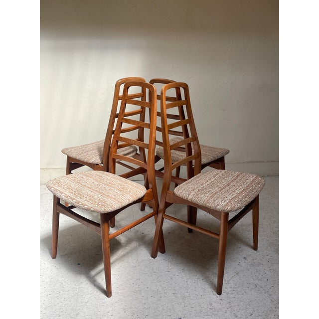 This set of 4 armless high-backed dining chairs features Danish design details in Teak and upholstery, and is attributed...