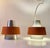 A rare set of hanging ceiling lamps in earthy orange and brushed aluminum. This model was made at nordisk solar compagni...