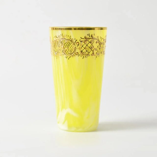 Small vase or tumbler made of yellow glass with a white swirl. Made by Franz Welz in the early 20th century. This piece is...
