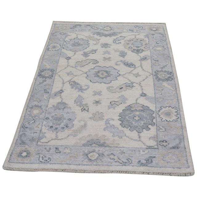 Hand-knotted with care using traditional rug-making techniques, this wool rug blends timeless craftsmanship with a modern...