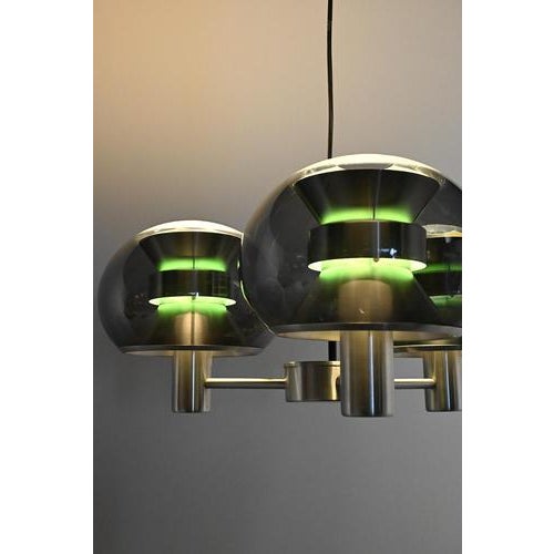 Space Age pendant from the Sixties made of a metal frame with transparent grey acrylic bulbs. When it is switched on it...