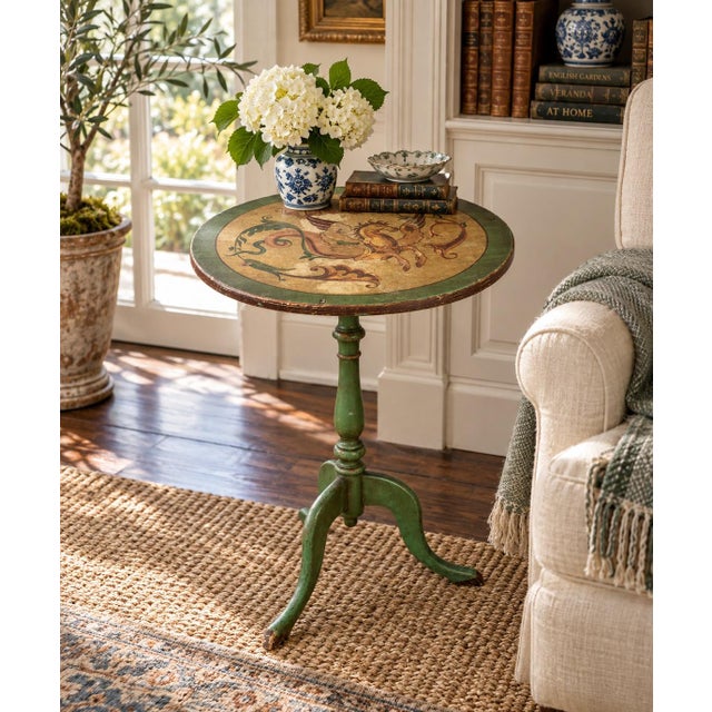 An elegant Regency-style flip-top side table in painted walnut, featuring hand-painted decoration against a green ground....