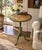 An elegant Regency-style flip-top side table in painted walnut, featuring hand-painted decoration against a green ground....