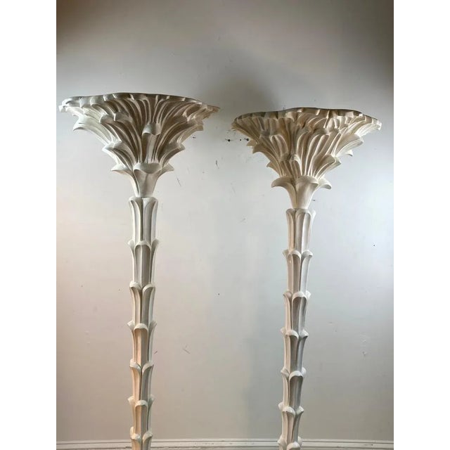 Exceptional pair of carved wood floor lamps in the manner of Serge Roche. Each measure 69” and 19” diameter. 21st century....
