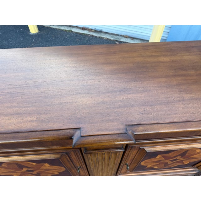 * Features stunning star-shaped marquetry inlay details on the door panels. * Has two upper drawers with small, round...