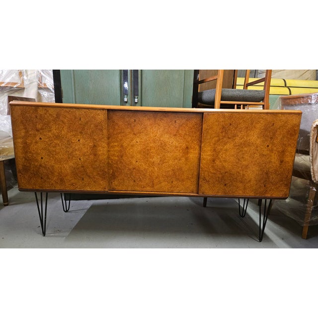 A beautiful sideboard cabinet raised on hairpin legs. the front is finished in a stunning birdseye maple whilst the top is...