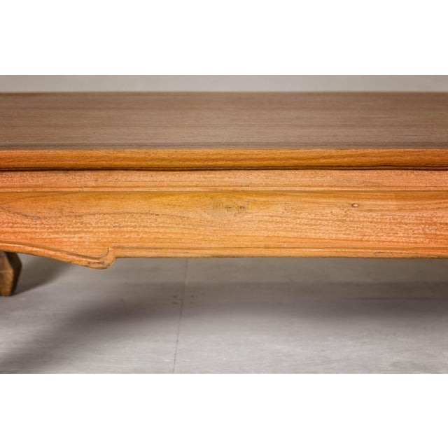 A Chow leg coffee table with waisted and carved apron and natural wood patina. This vintage Chow leg coffee table,...