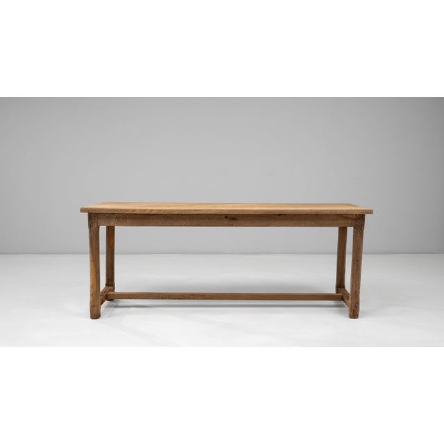 This 1900s French oak dining table features a beautifully understated design that highlights the natural character and...
