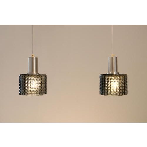 A unique set of glass pendant lamps designed by Carl Fagerlund for Orrefors in Sweden. The lamps feature beautifully...