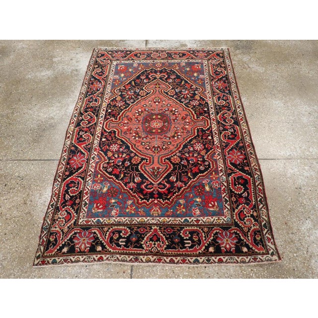 This Early 20th century Persian Sarouk rug, measuring 3' 5" x 6' 6", is a superb example of the artistry and elegance that...