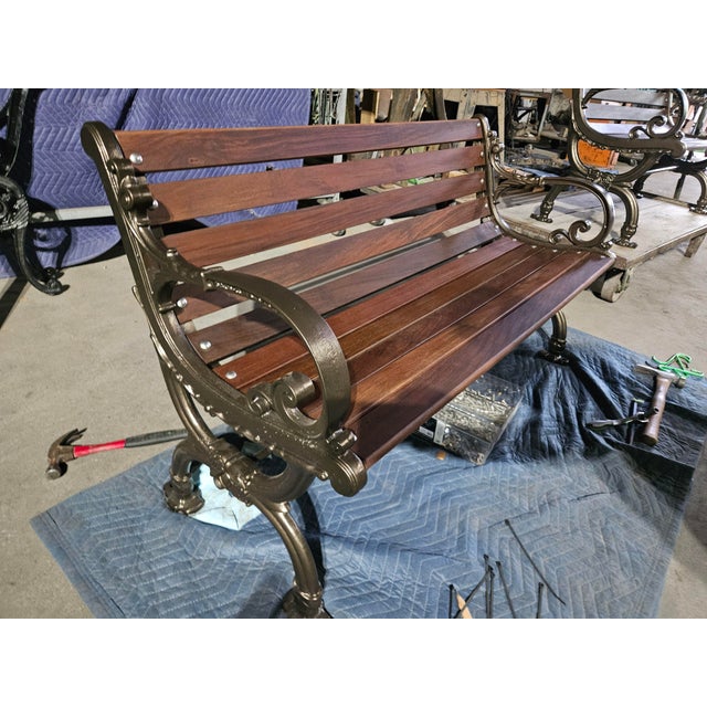 Restored cast iron garden bench featuring vintage legs by Bench Mfg. Co., Woodstock, Vermont, rebuilt with rich oiled Ipe...