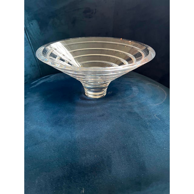 Crafted with exceptional weight and clarity, this signed Nambé art glass bowl features a dramatic, flared modern...