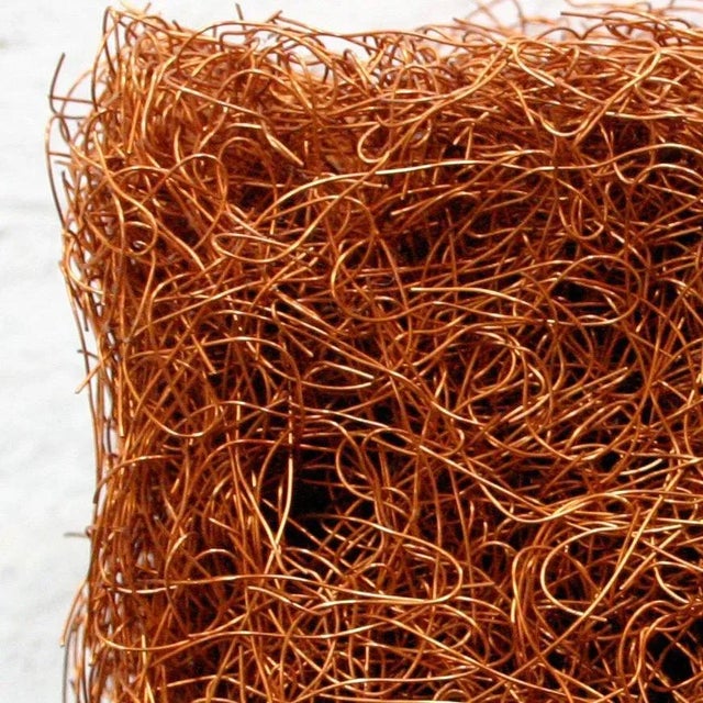 Constructed out of copper wire, densely woven, looks good mounted on a wall as well as sitting or hanging.