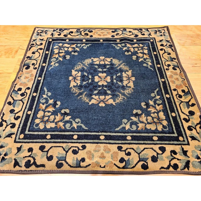 2’ 8” x 2’ 8” 19th century square size Chinese Peking area rug in a tan, navy blue and French blue colors. The rug has a...