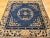 2’ 8” x 2’ 8” 19th century square size Chinese Peking area rug in a tan, navy blue and French blue colors. The rug has a...