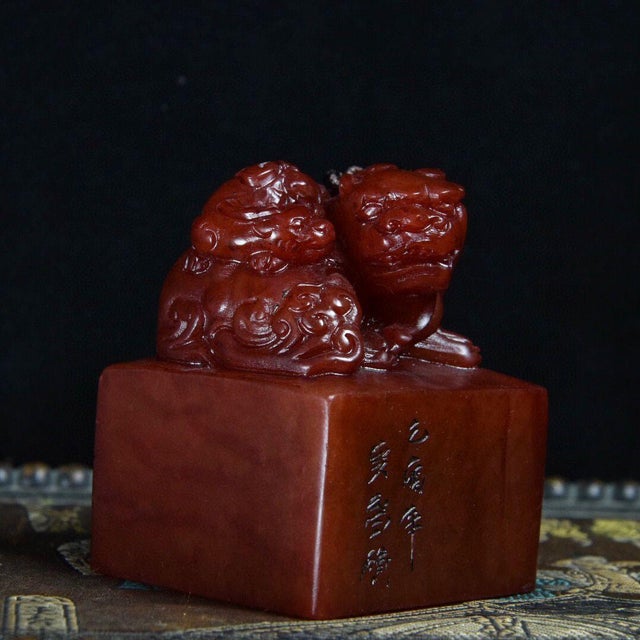 A substantial Chinese scholars' seal carved from warm, rich red-brown Shoushan stone with an oily, lustrous patina. The...