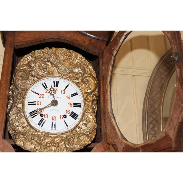 Antique French long case repeater clock with an unusual and varied shape oak case. The face is enamel and surrounded by...