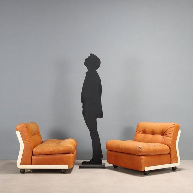 Two 'Amanta' armchairs with a plastic frame, foam padding, and leather upholstery, original from the period. They show...