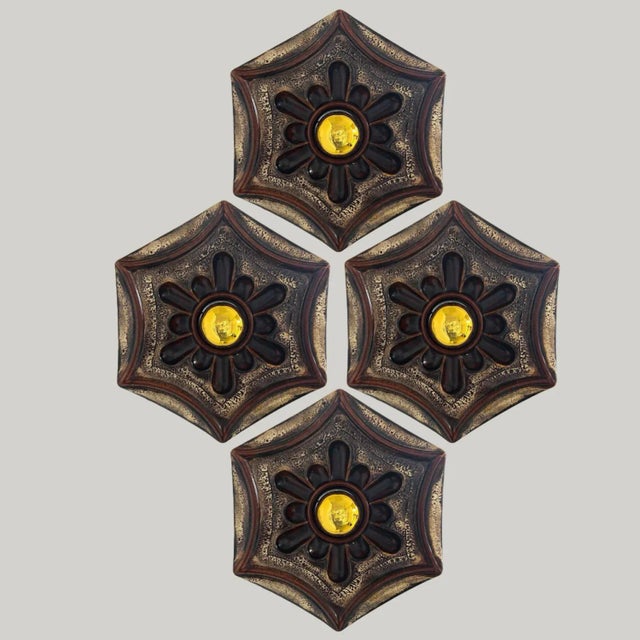 Gold hex- and star-shaped ceramic wall lights in Fat Lava style. Manufactured in Germany in the 1970s. The base of the...