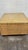 This is really a no brainer. Perfectly vintage wicker cube coffee table on plinth base with glass top. Really great...
