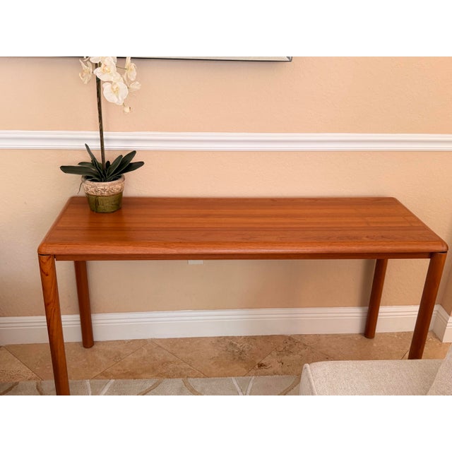 An exceptional, minimalist Mid-Century Modern teak console table designed and manufactured by Sannemann in Denmark during...