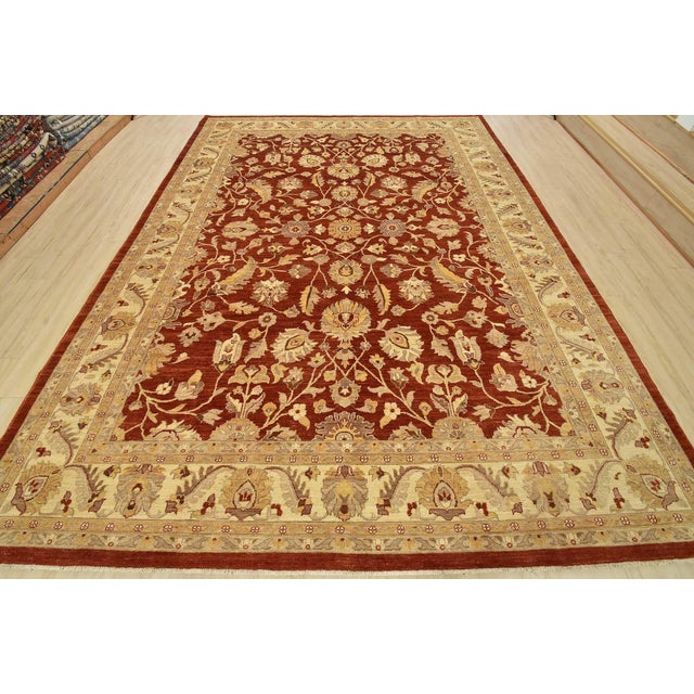 A traditional Ziegler rug hand-knotted with fine wool on a cotton foundation. This rug features a botanical design set...
