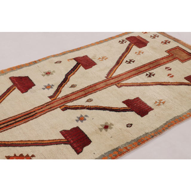 Hand-knotted in wool circa 1950-1960, this 4x6 vintage Persian Gabbeh rug is a standout entry in Rug & Kilim’s curation of...