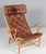 Bruno Mathsson Pernilla lounge chair with patinated leather. Frame in beech. Made by DUX. 25 years annivesary model This...