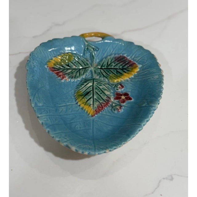 A gorgeous, instantly curated trio of late 19th-century Victorian majolica leaf dishes, presenting a magnificent display...