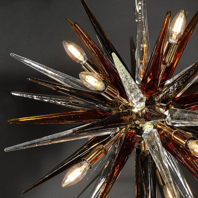 This striking Murano glass chandelier offers a modernist interpretation of the iconic Sputnik design, showcasing hand-...