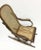 A bended beech wood rocking chair with rattan seat circa 1900, England Beautiful dark colored wooden chair with rattan...
