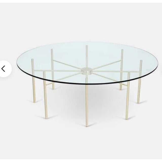 Radial glass coffee table by Lawson Fenning (unmarked) with a polished brass spoke base with 1/2 inch glass top. Retails...