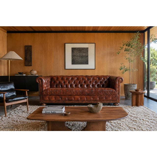 This exceptional vintage Chesterfield sofa embodies the timeless elegance and craftsmanship that have defined the style...