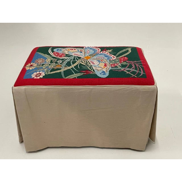 A strikingly beautiful handmade rectangular bench having one of kind butterfly and floral needlepoint top and inverted...