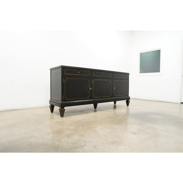 This Lillian August Foster Three Door Server showcases a sophisticated neoclassical-inspired design with a rich black...