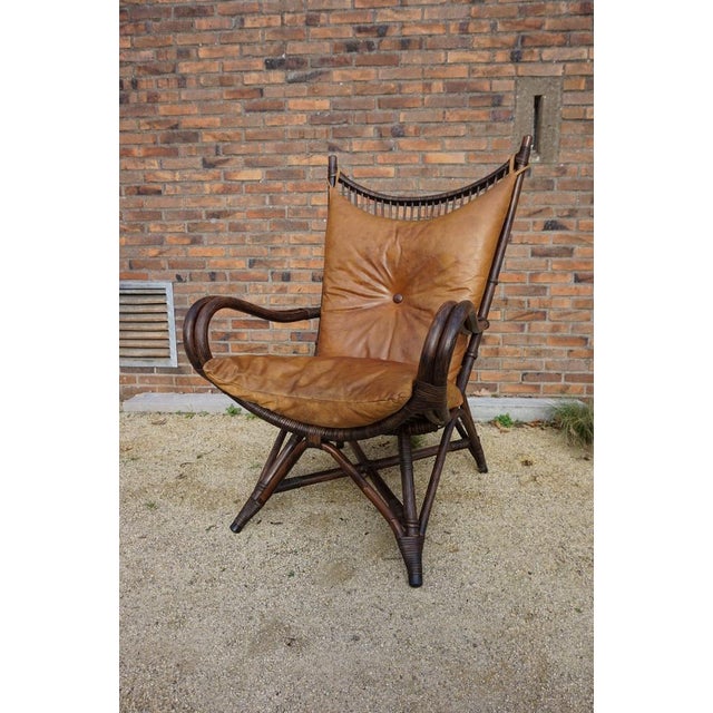 Bamboo fan back lounge chair with cognac colored leather cushions, around 1960s The design of this rattan chair is unique...