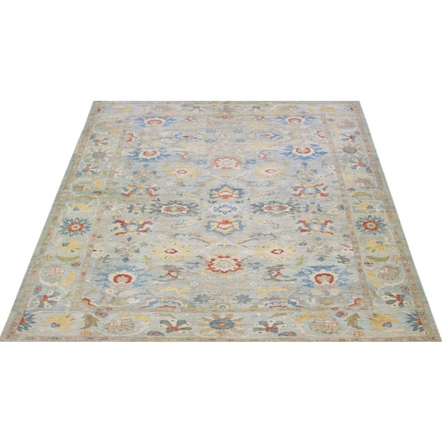 Beautiful modern Sultanabad hand-knotted wool rug with a light blue color field. This rug has a designed frame with...