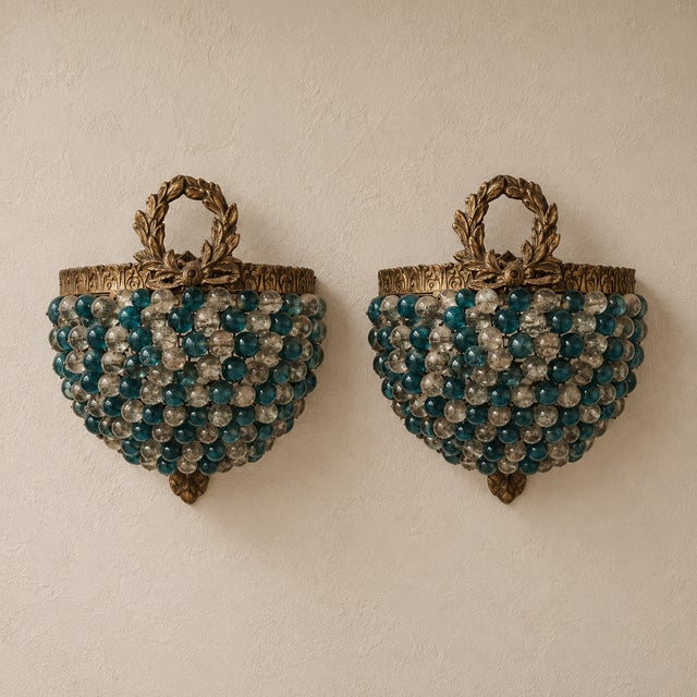 Add a charming touch of French-inspired elegance with this matching pair of petite wall sconces, featuring layers of blue...