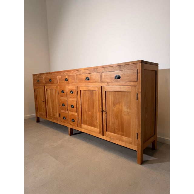 Impressive solid teak sideboard offering exceptional storage capacity and timeless craftsmanship. Featuring a warm natural...