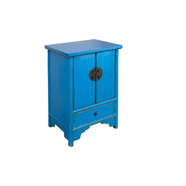 This striking Chinese-style accent cabinet is finished in a vibrant, weathered cerulean blue that highlights the natural...