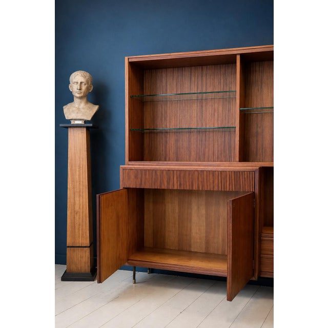 Elegant italian mid-century modern cabinet and bookcase, dating from approximately the 1950s and distinguished by its...