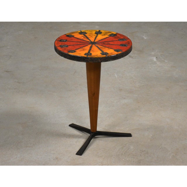 A mid century modern red and orange ceramic side table by Aldo Londi Bitossi. Solid cherry shaft and iron legs. Circa...