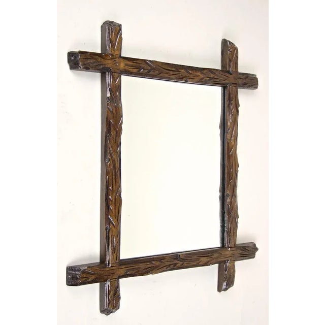 From Austria around 1880 comes this unusual rustic small Black Forest mirror, impressing with its extraordinary old tree...