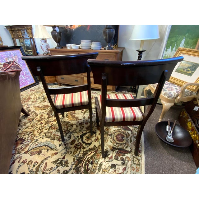 Pair of 19th Century English Regency wood chairs. Carved turned legs, carved detail. Upholstered seats. Legs are a bit...